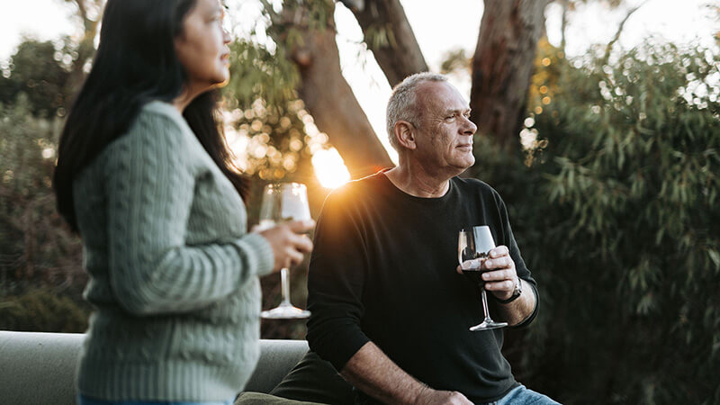 Couple drinking wine and looking out at the sunset